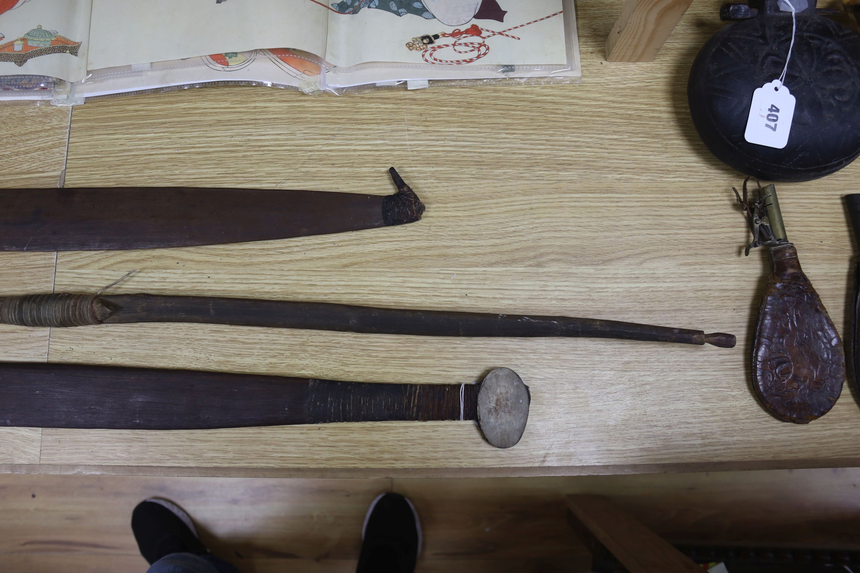 Two chip-carved paddle blades and bow, possibly Fijian.